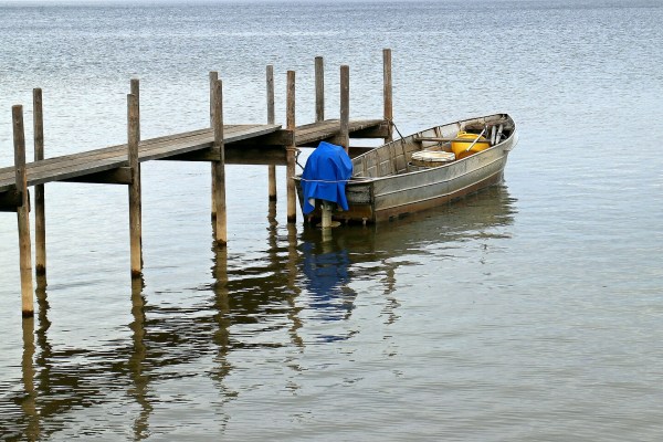 empty boat tied to small pier